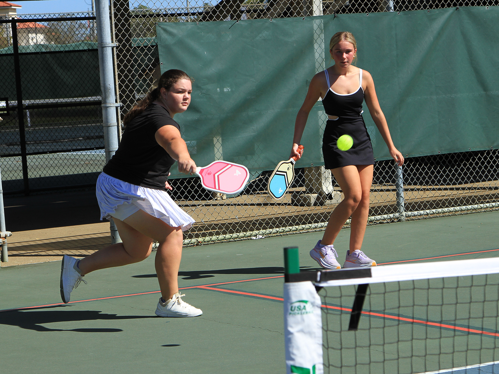 pickleball player hitting ball