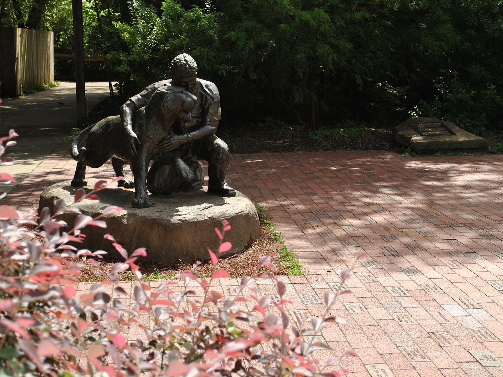 statue and engraved brick patio